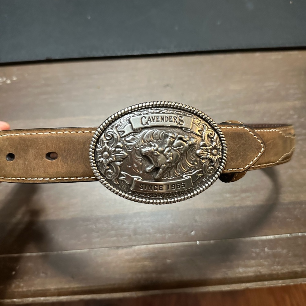 Cavenders belt buckle on brown leather belt